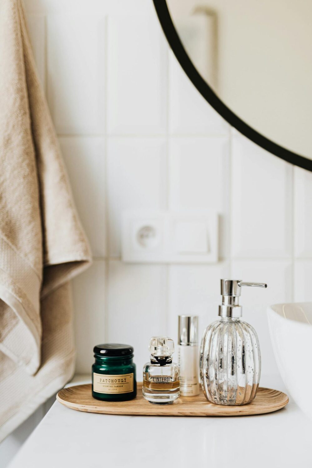 Photo by Karolina Grabowska Composition of liquid soap perfume and skincare products placed on bamboo plate in modern bathroom